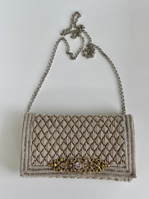 The pique silver clutch