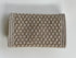 The pique silver clutch