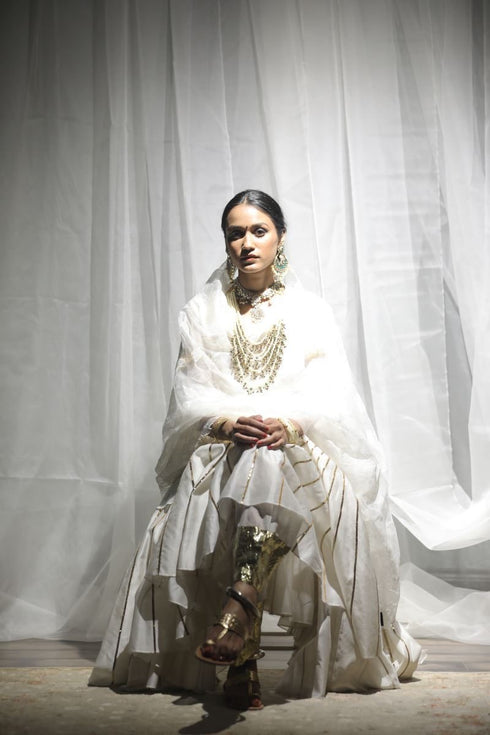 Aikeyah off white layered top paired with skirt, gota salwar and dupatta